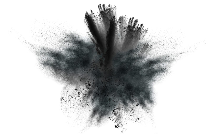 Closeup of black dust particles explosion isolated on white background.